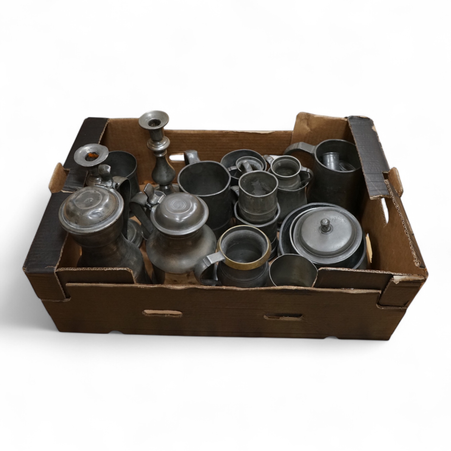 A quantity of pewter to include tankards, dishes and a pair of candlesticks